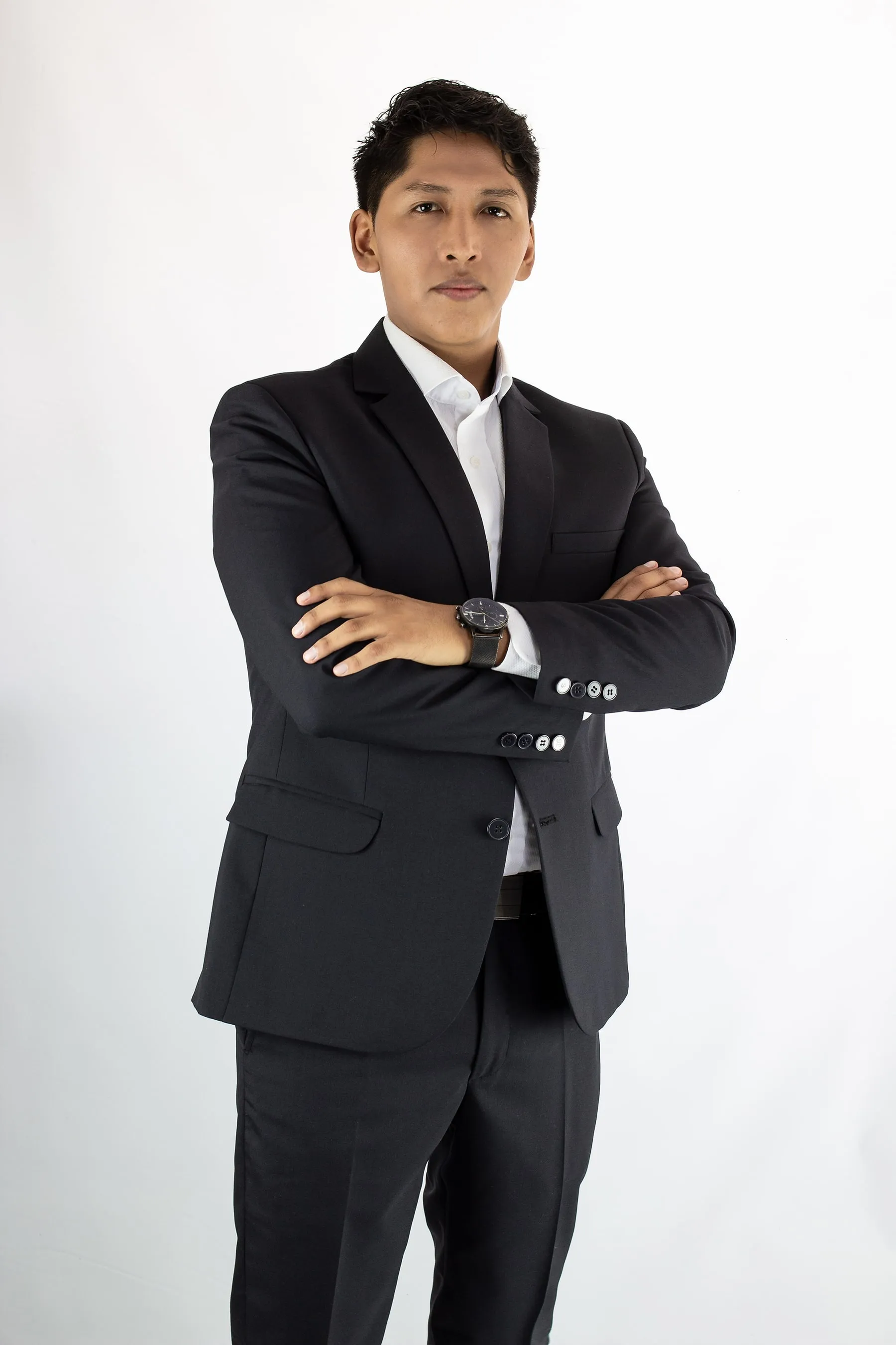 Kenji Hilasaca wearing a dark suit against a white studio background